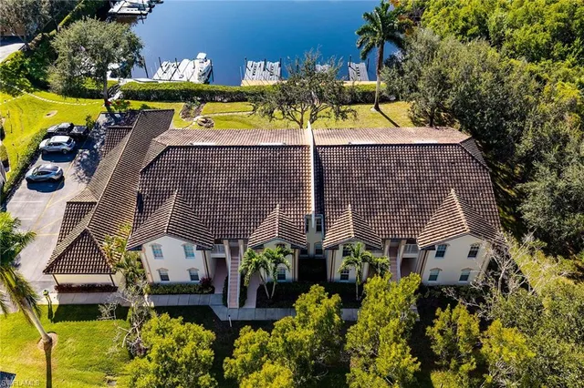 an aerial view of a house with a yard swimming pool and outdoor seating