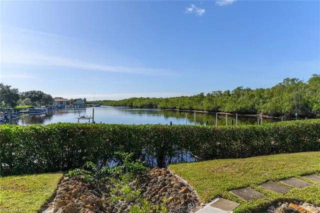 a view of a lake with houses in the back