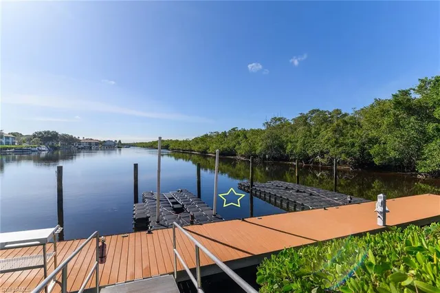 a view of a lake with couches in patio