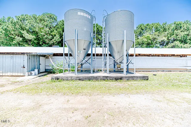a front view of house with yard and trees in the background