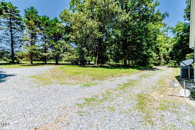a bathroom with a granite countertop sink mirror and toilet