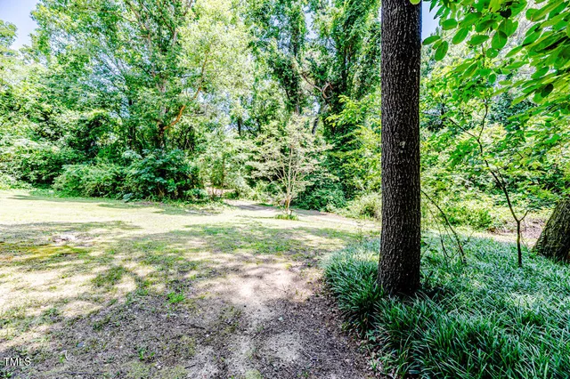 a view of a hallway with wooden floor and stairs