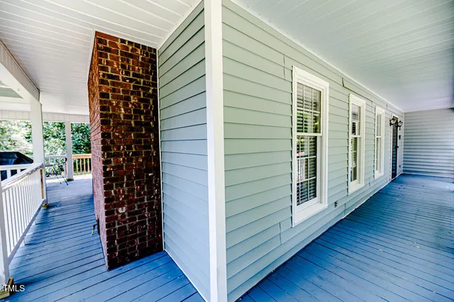 a bathroom with a granite countertop sink a mirror and shower