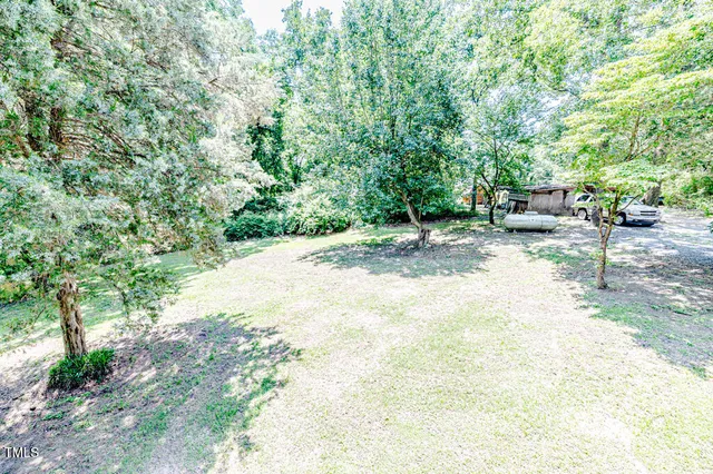 a living room with furniture a bed and large windows