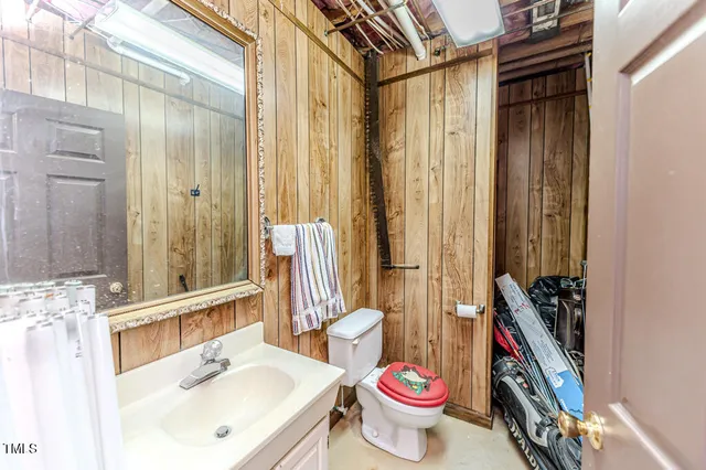 a bathroom with a sink toilet and shower curtain
