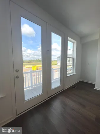 a large kitchen with stainless steel appliances lots of counter top space and wooden floor
