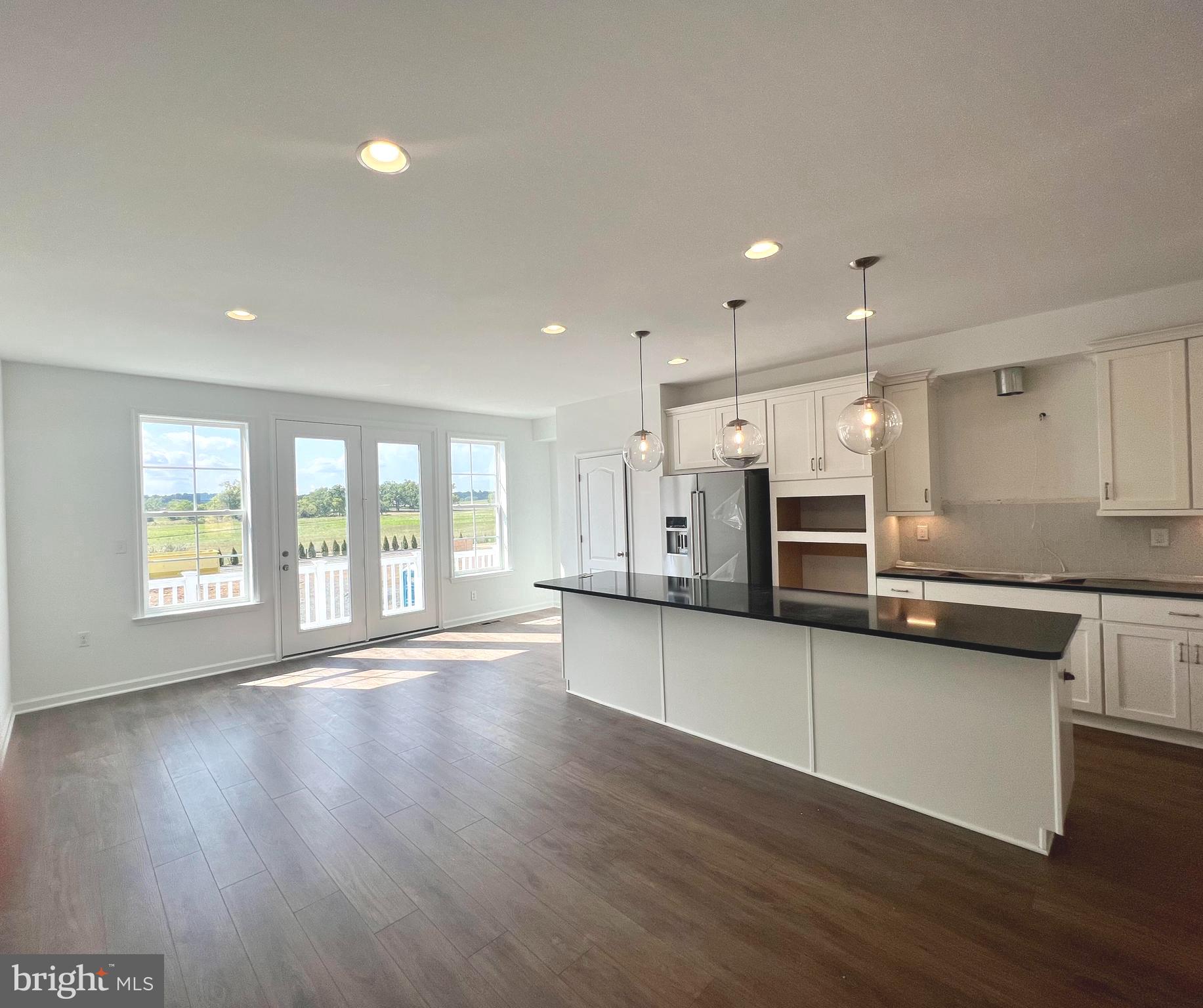 3141 Eton Place Winchester, VA 22601 - Photo 13 of 41 a large kitchen with stainless steel appliances lots of counter top space and wooden floor
