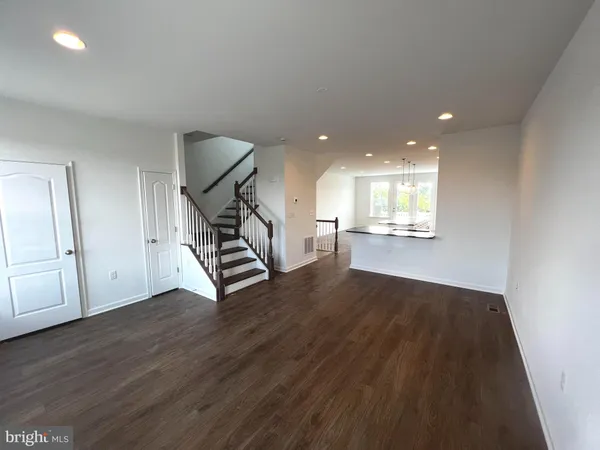 a floor to ceiling window and stainless steel appliances
