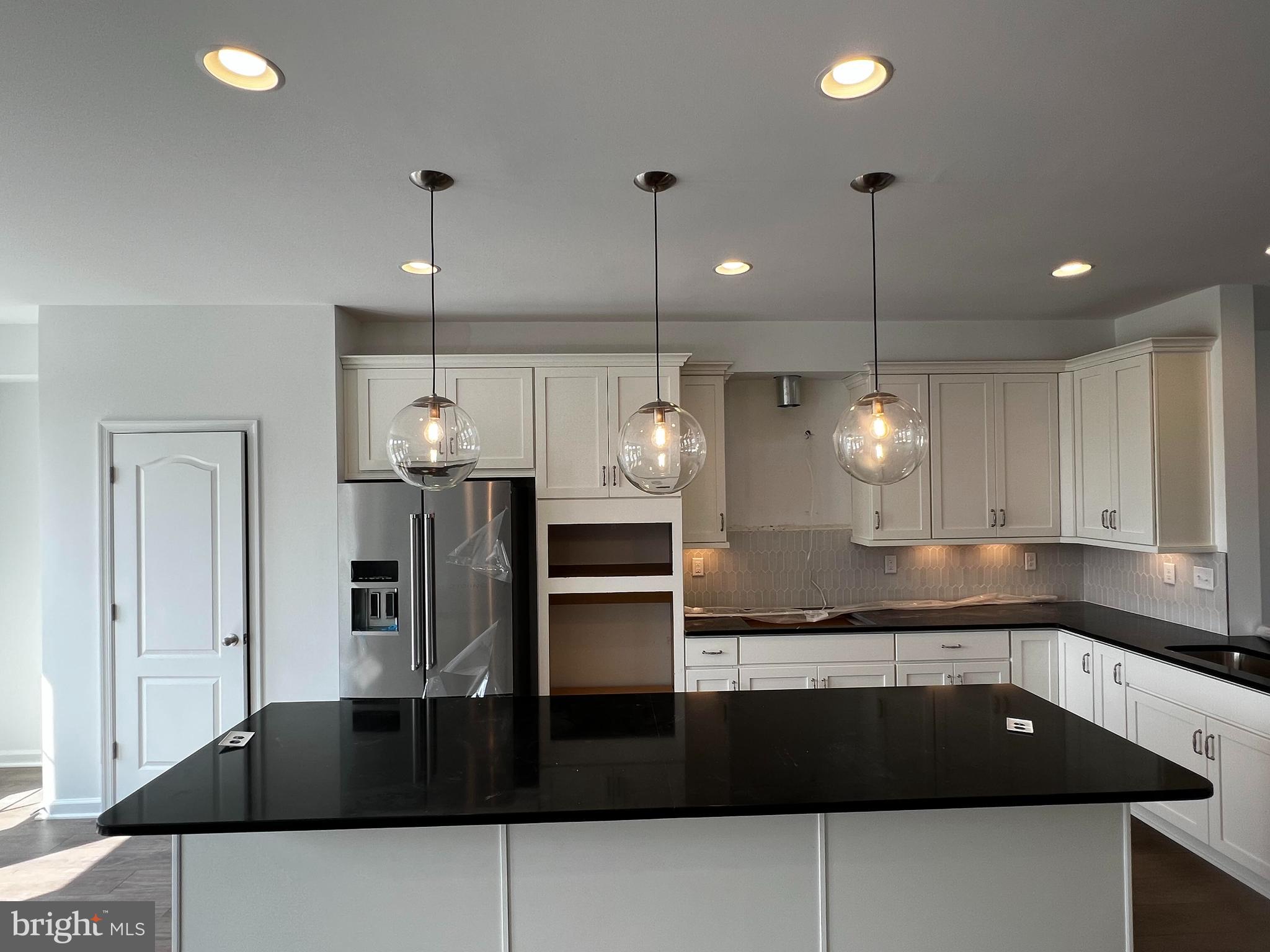 3141 Eton Place Winchester, VA 22601 - Photo 18 of 41 a kitchen with a sink a counter and cabinets