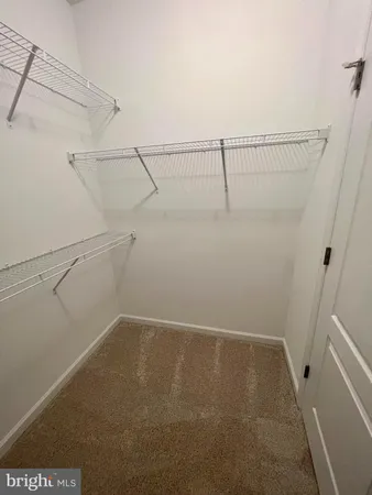 a bathroom with a granite countertop sink a mirror a bathtub and a window