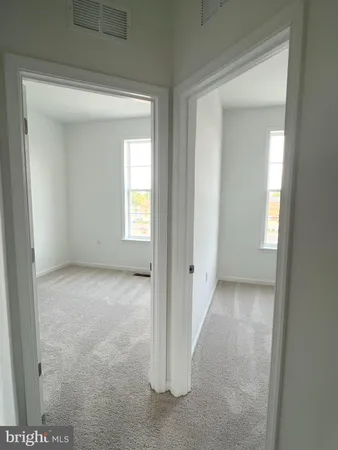 a view of an empty room and a window