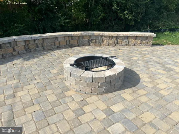 a view of a backyard with a table and chairs under an umbrella