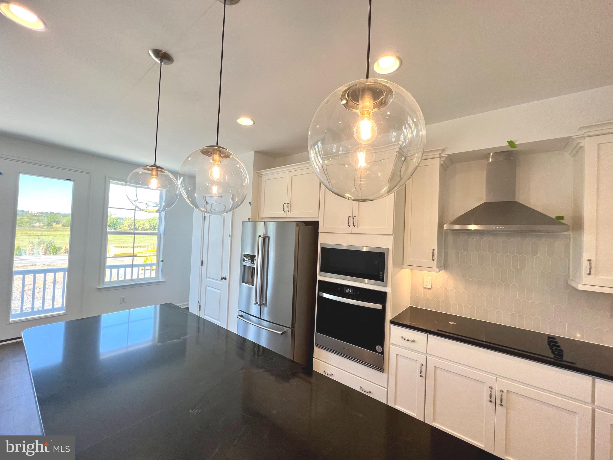 3141 Eton Place Winchester, VA 22601 - Photo 10 of 41 a kitchen with granite countertop a stove a refrigerator and a wooden floors