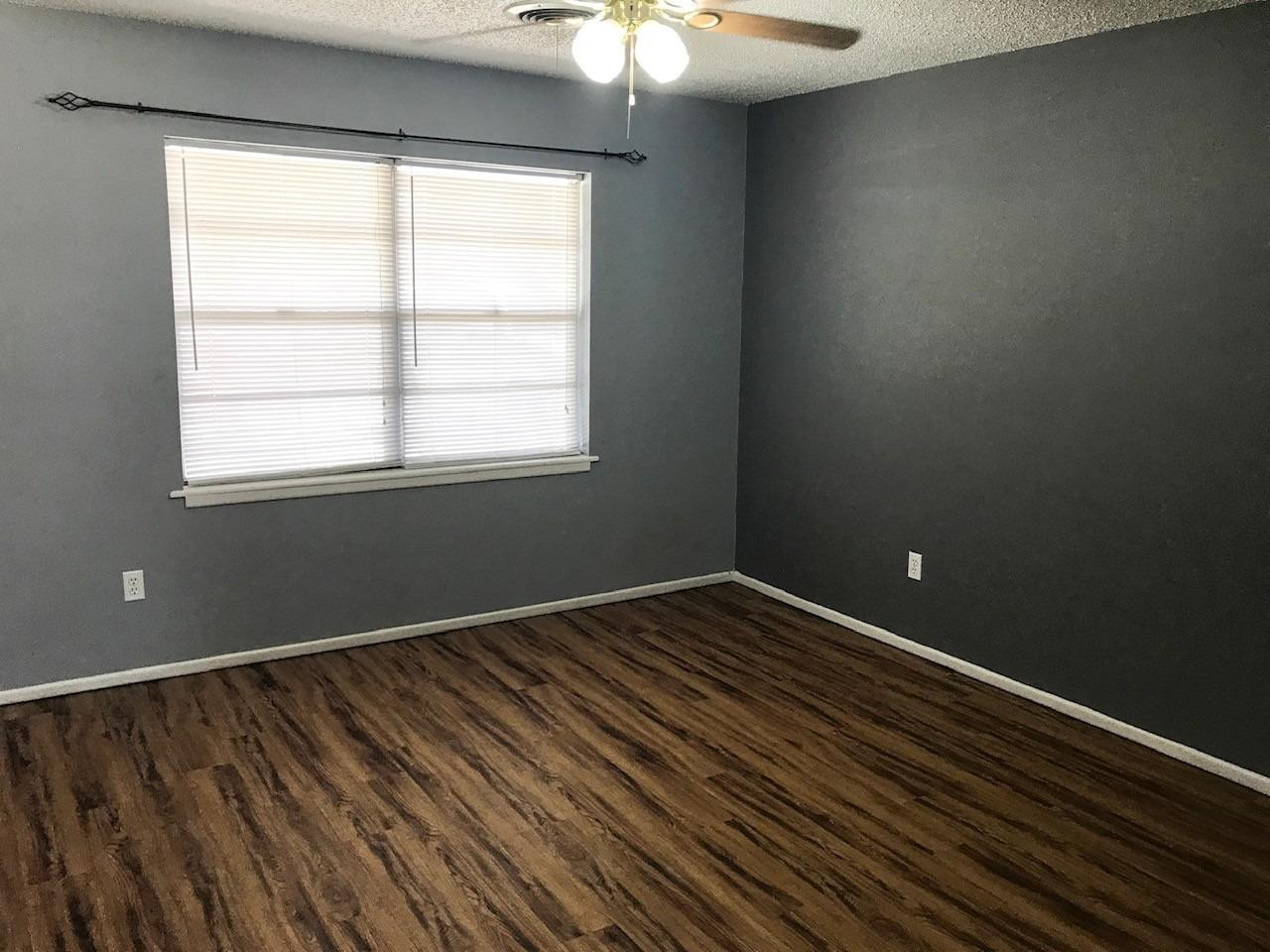 3520 Bangor Drive Lubbock, TX 79407 - Photo 3 of 11 wooden floor in an empty room with a window