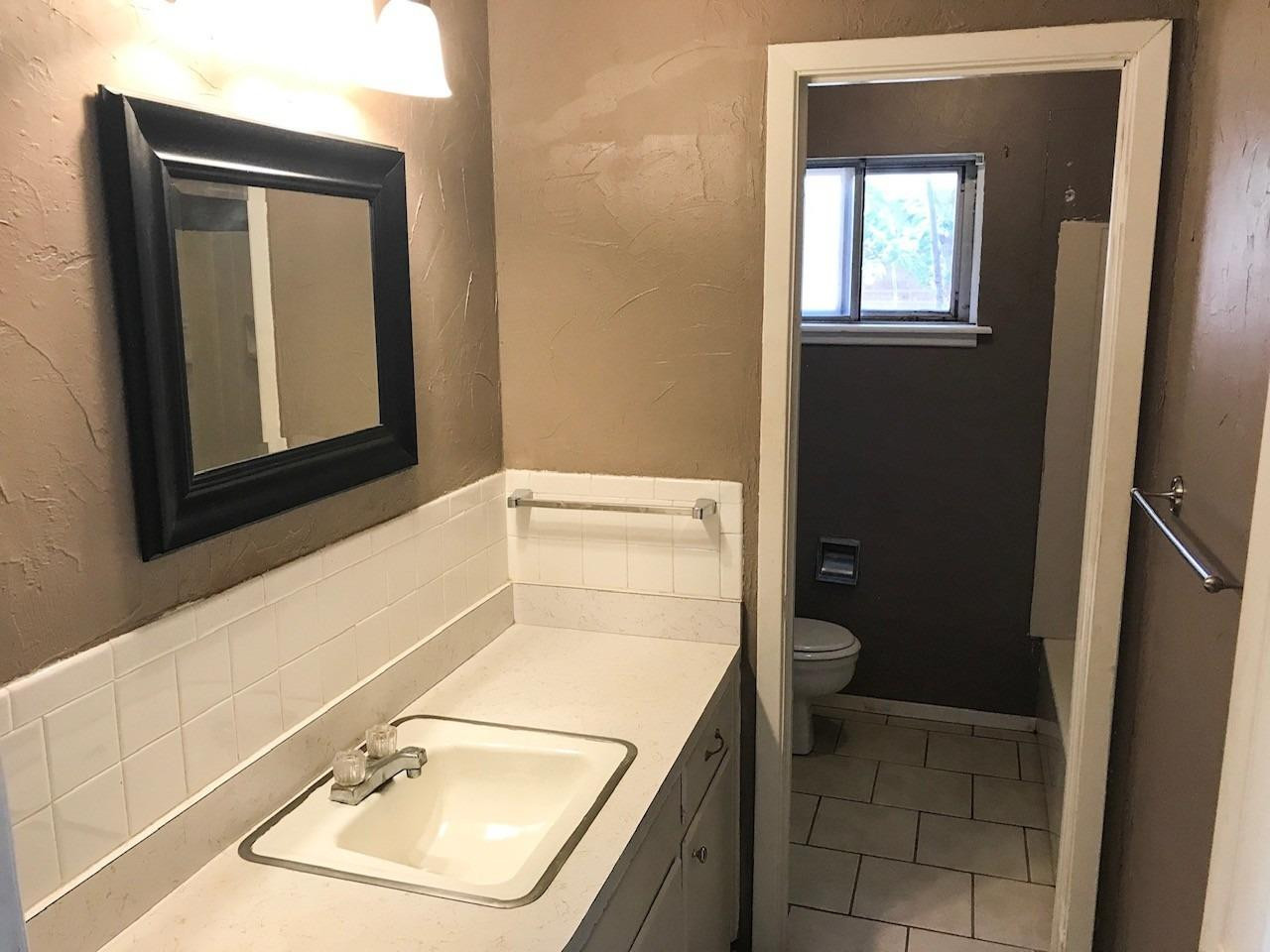 3520 Bangor Drive Lubbock, TX 79407 - Photo 5 of 11 a bathroom with a sink toilet and mirror