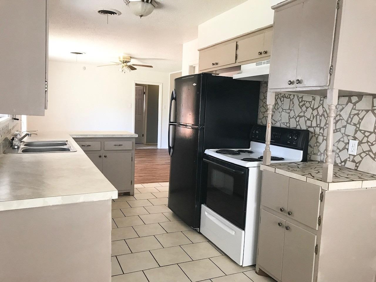 3520 Bangor Drive Lubbock, TX 79407 - Photo 7 of 11 a kitchen with a sink and a stove top oven