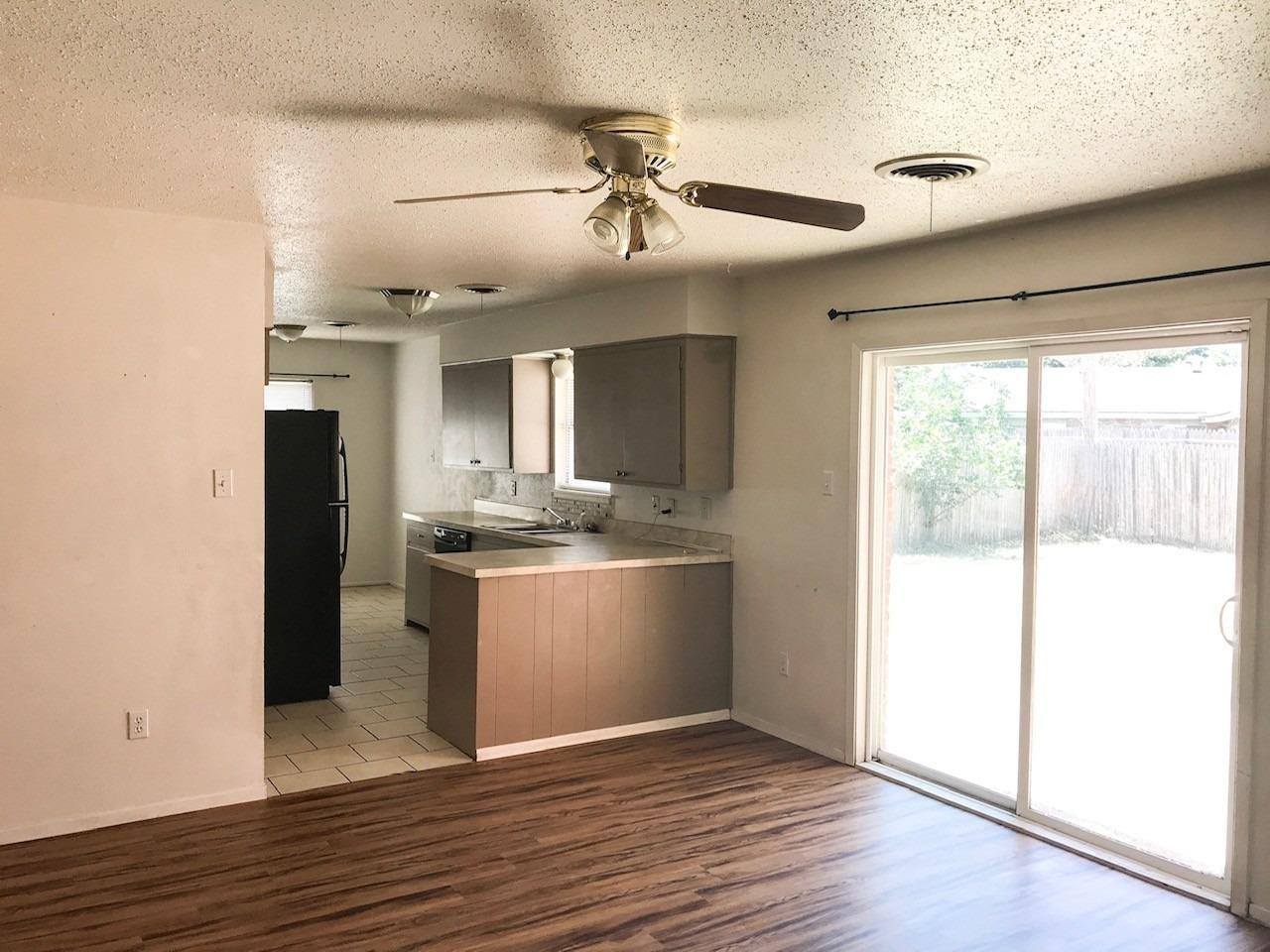 3520 Bangor Drive Lubbock, TX 79407 - Photo 8 of 11 a view of an empty room with wooden floor and a window