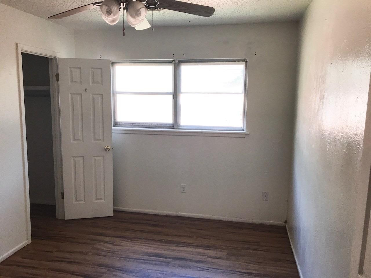 3520 Bangor Drive Lubbock, TX 79407 - Photo 9 of 11 an empty room with wooden floor and windows
