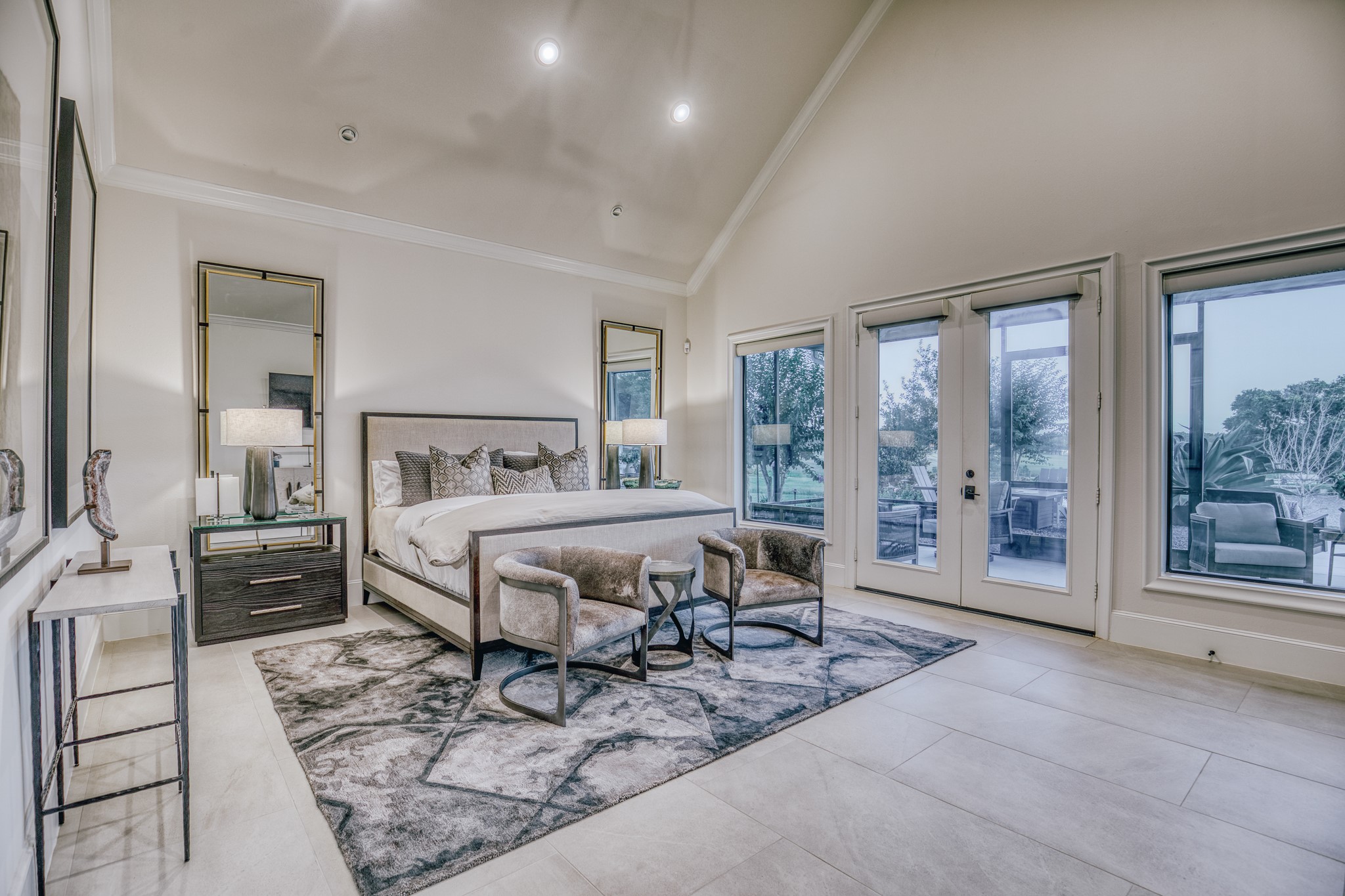 1034 Hilbun Road New Ulm, TX 78950 - Photo 23 of 49 Private primary retreat offering generous proportions, serene pond views, direct outdoor access, and a peaceful atmosphere designed to capture the beauty of the surrounding landscape.