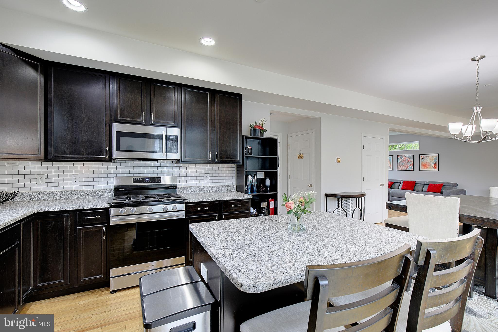 403 Venton Road Edgewater, MD 21037 - Photo 21 of 62 a kitchen with kitchen island granite countertop stainless steel appliances cabinets a sink and a island