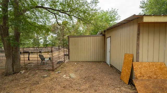 a view of a house with a yard and fence