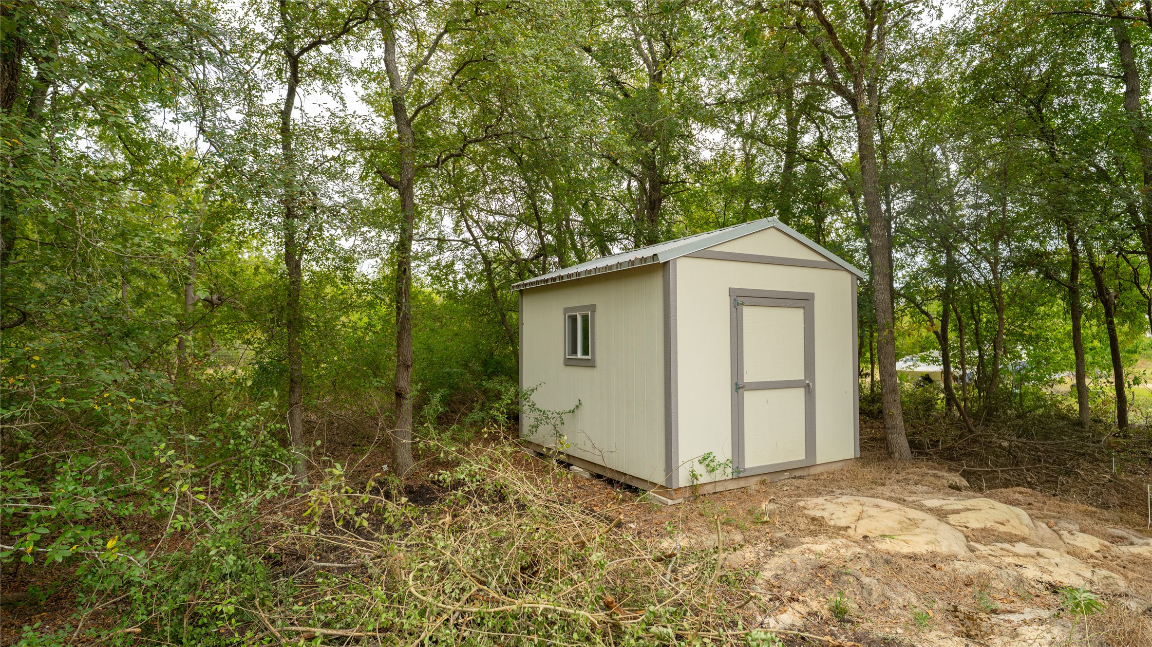 2348 County Road 404 Loop Bartlett, TX 76511 - Photo 5 of 40 View of shed featuring view of scattered trees