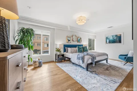 a bedroom with a bed and a potted plant