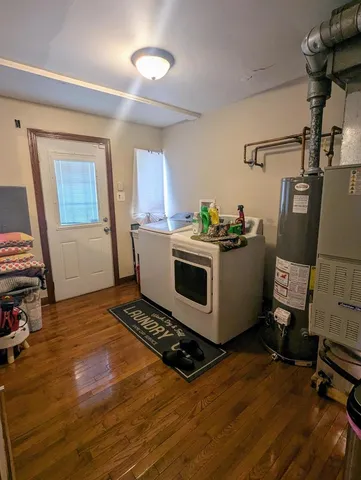 a room with furniture a rug and a window