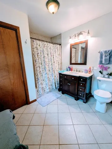 a living room with a baby crib furniture a sink and a mirror