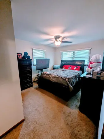 a bedroom with a bed and a chandelier