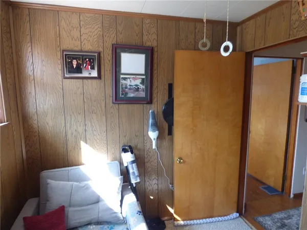 a view of a hallway with couch and closet