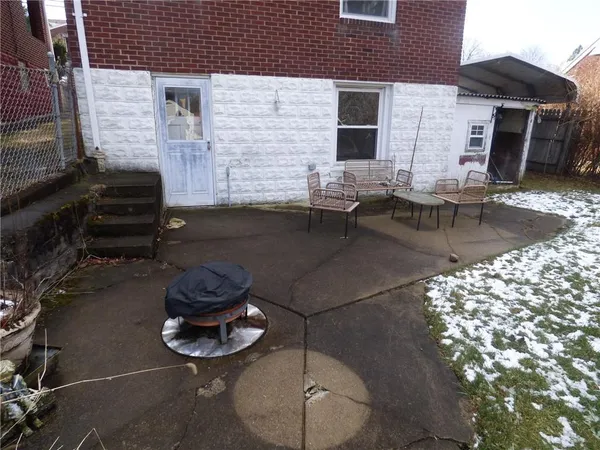 a backyard of a house with outdoor seating