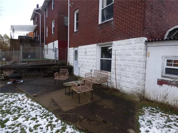 a brick building with a bench in front of it