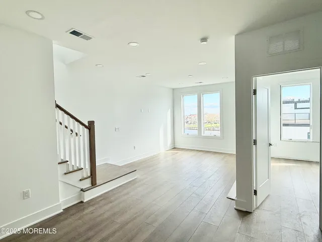 a view of an entryway with wooden floor