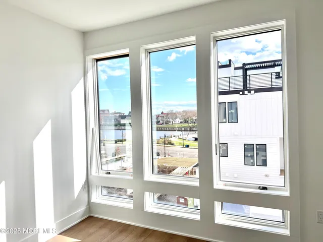 a view of an entryway with wooden floor
