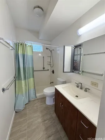 a spacious bathroom with a sink toilet and shower