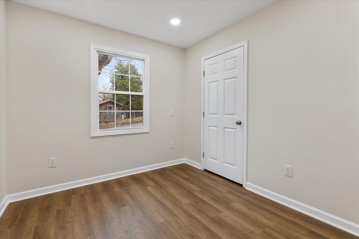 127 State Pulaski, VA 24301 - Photo 10 of 35 an empty room with wooden floor and windows
