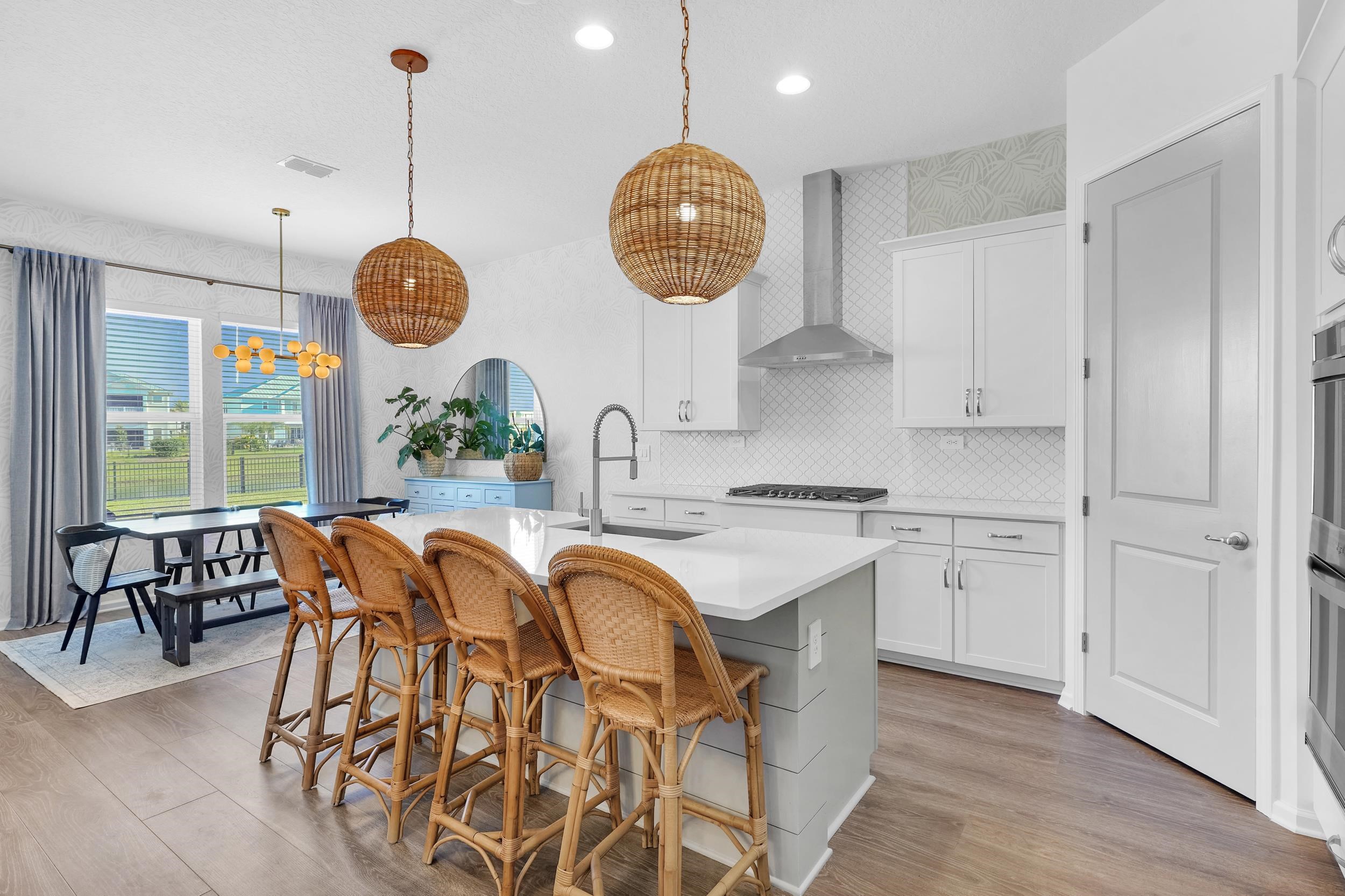 404 Rum Runner Way St. Johns, FL 32259 - Photo 17 of 41 a very nice looking kitchen with granite countertop a stove two sinks and a chandelier