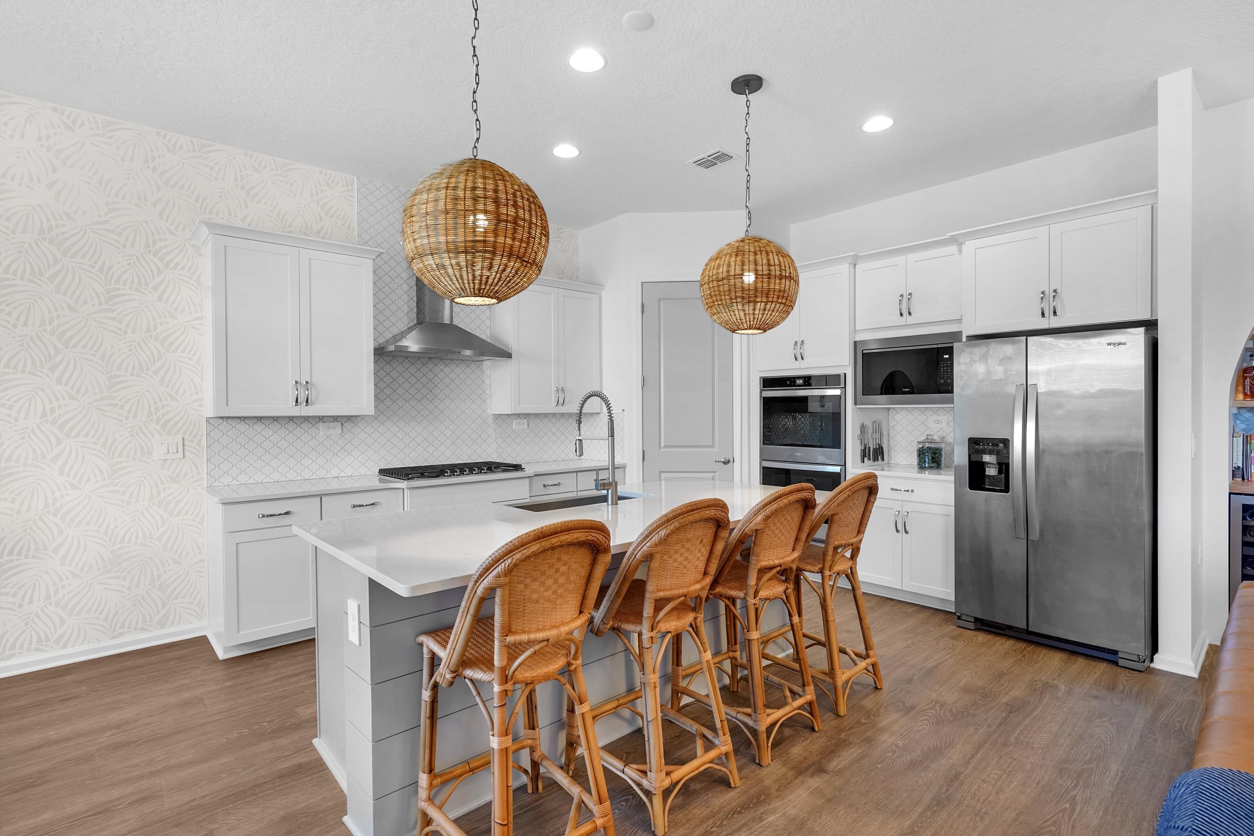 404 Rum Runner Way St. Johns, FL 32259 - Photo 20 of 41 a kitchen with stainless steel appliances granite countertop a stove a sink a refrigerator and a dining table