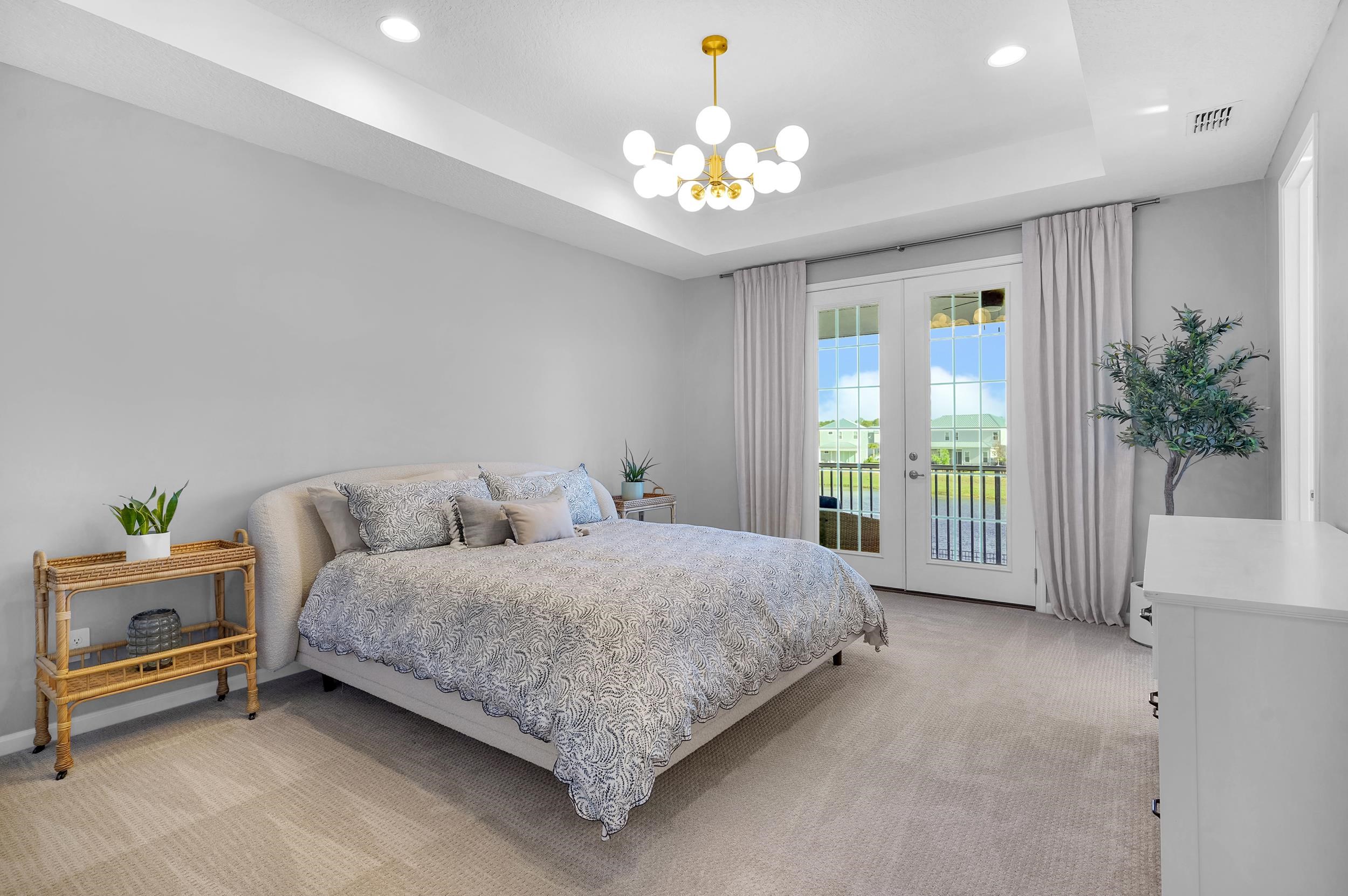 404 Rum Runner Way St. Johns, FL 32259 - Photo 27 of 41 a bedroom with a bed and a chandelier