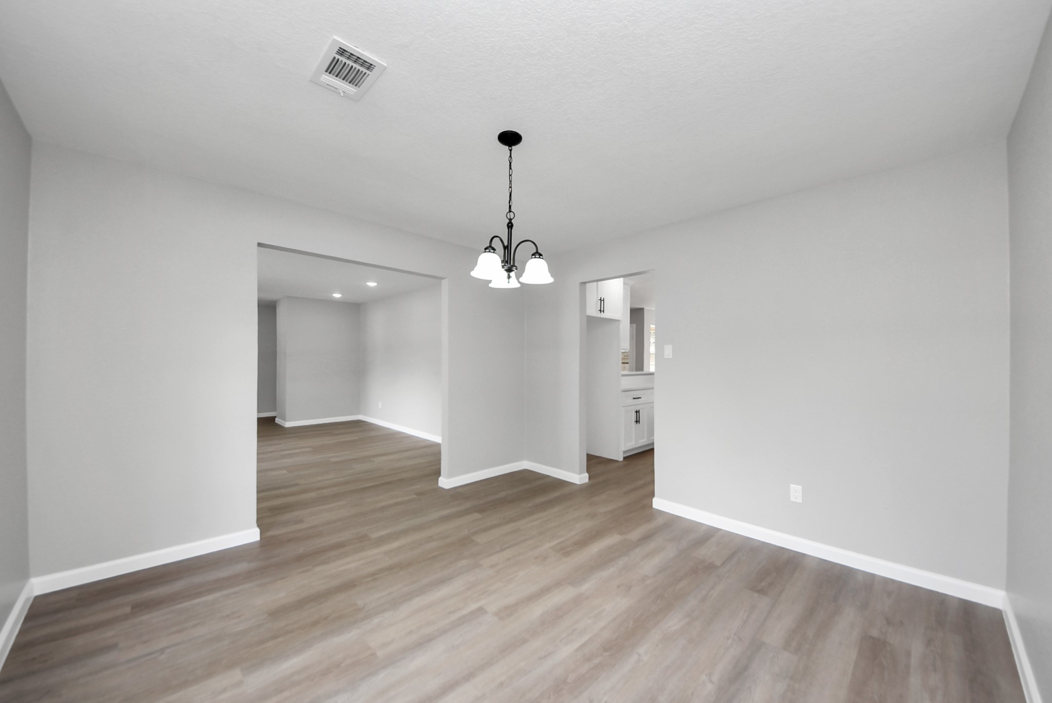2402 Rolling Glen Drive Spring, TX 77373 - Photo 16 of 38 a view of a room with wooden floor chandelier and a window