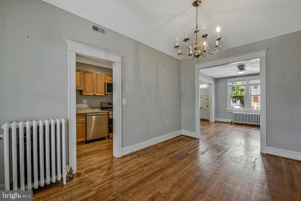 2406 37th Street Northwest Washington, DC 20007 - Photo 19 of 44 a view of a hallway with wooden floor and a living room