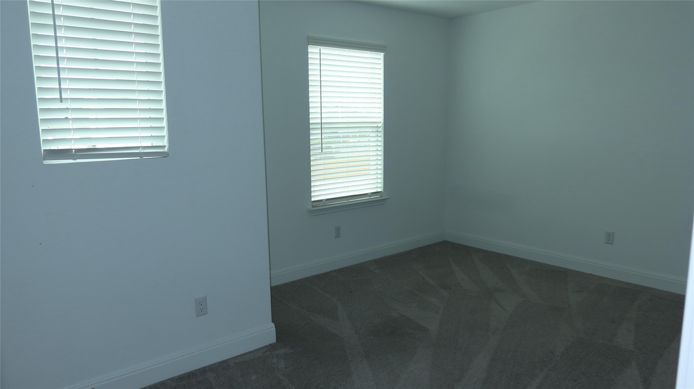 620 Acuff Lane Leander, TX 78641 - Photo 8 of 14 Neutral wall paint with two windows featuring horizontal blinds
