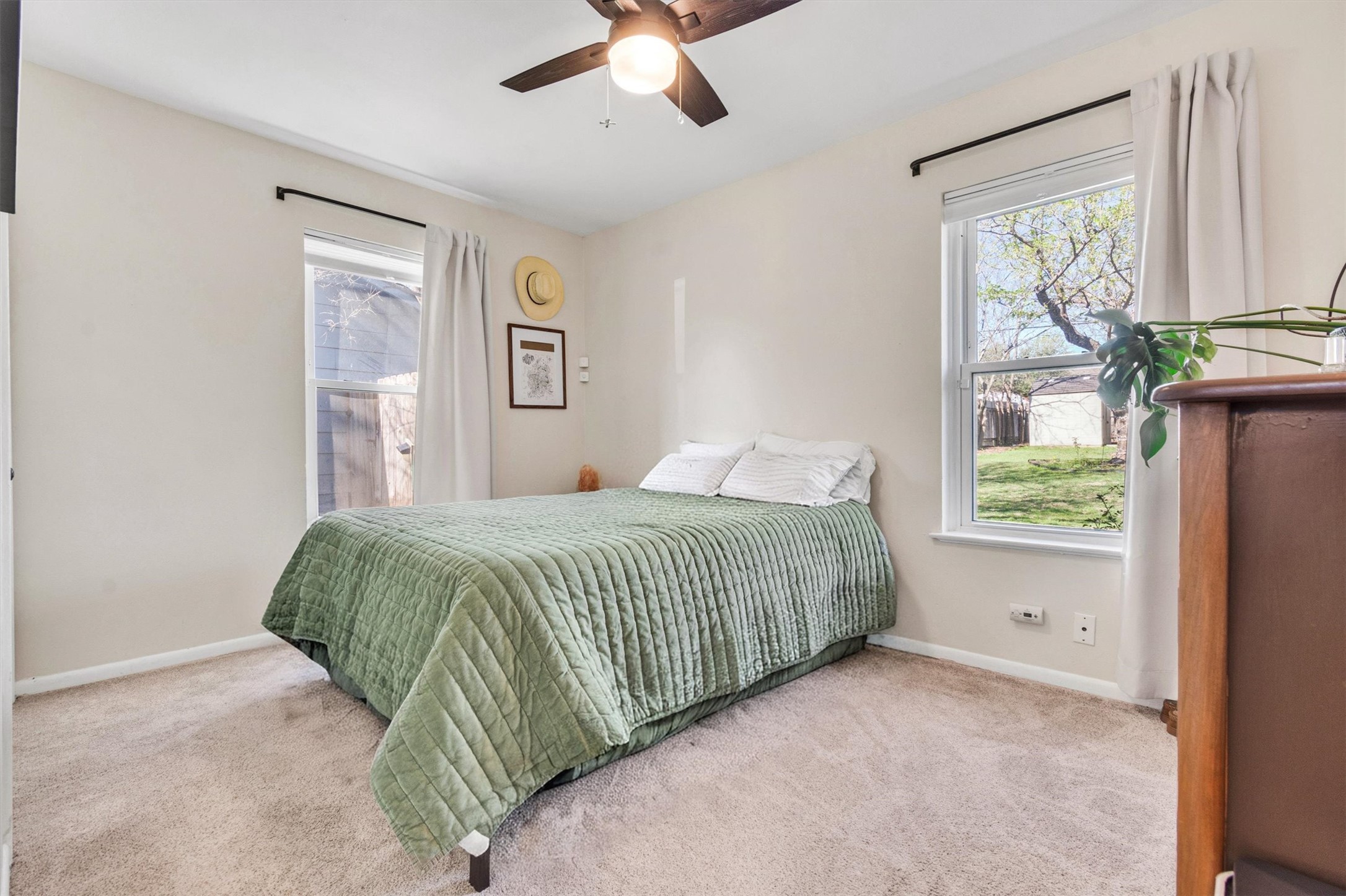 8800 Redfield Lane Austin, TX 78758 - Photo 16 of 27 Bright and comfortable guest bedroom with ceiling fan.