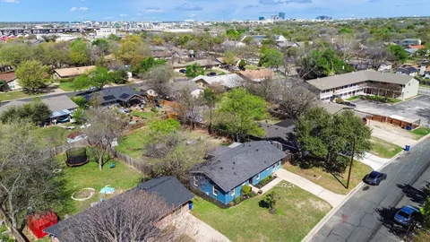 an aerial view of a house with a yard
