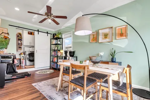 a view of a dining room with furniture and a ceiling fan