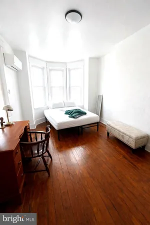 a view of a room with furniture and wooden floor