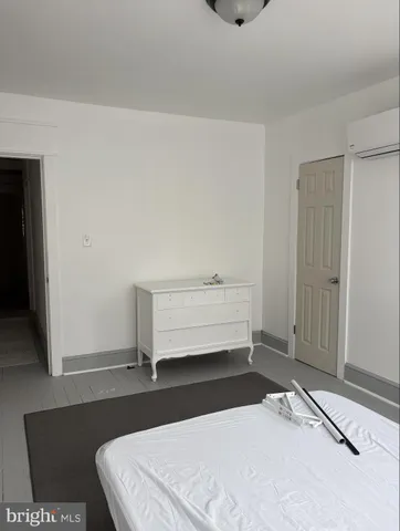 a bedroom with a bed and a night stand