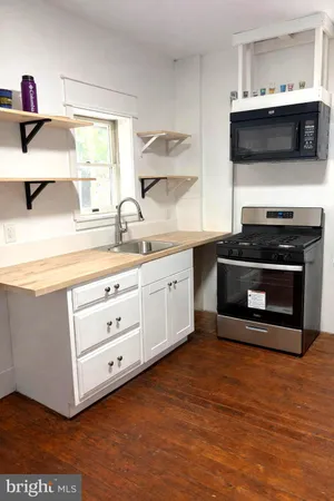 a kitchen with stainless steel appliances a stove microwave and cabinets