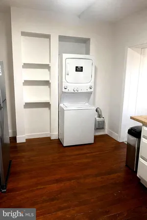 a view of kitchen with wooden floor and electronic appliances